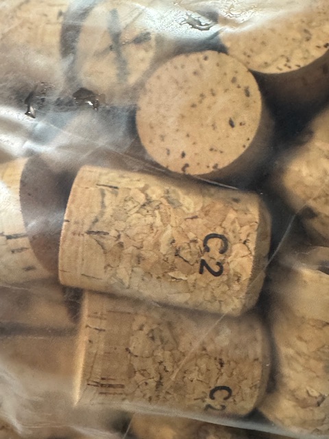Corks, before being inserted, mushroomed and caged.